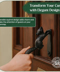 Hand using Black Cast Iron Squirrel Shaped Door Knocker With Mounting Hardware, 6.75 Inch Front Door Accessory, Weatherproof Finish