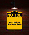 Golf Swing Analyzer Area Notice Sign In Yellow And Black Aluminum Composite Weatherproof Durable Sign Board Eight Point Five By Ten Inches Displayed on Brick Wall