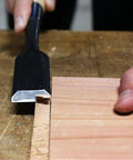 Heavy Duty Japanese Wood Chisel One Inch Hand Forged White Steel Number Two Blade razor sharp edge in use on wood for joinery.