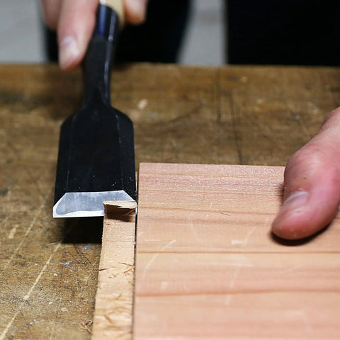 Heavy Duty Japanese Wood Chisel One Inch Hand Forged White Steel Number Two Blade razor sharp edge in use on wood for joinery.