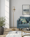 Nautical Floor Lamp With Glass Shade In Brass And Clear Finish next to blue sofa in living room, Lantern Style Lighting for cottage vibes.