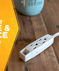 Slimline Flat Plug Extension Cord 6 Foot 16 Gauge 3 Conductor 3 Outlet Indoor White Wall Saver on wooden table