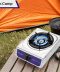 12000 BTU Propane Camping Stove With Auto Ignition for Outdoor Cooking next to orange tent, includes CSA Regulator and Gas Hose