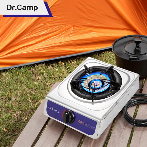 12000 BTU Propane Camping Stove With Auto Ignition for Outdoor Cooking next to orange tent, includes CSA Regulator and Gas Hose