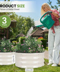 Person watering plants in Round Raised Garden Bed Set Of 3 Galvanized Steel Planter Boxes 2x2x1ft With Rubber Edge Trim