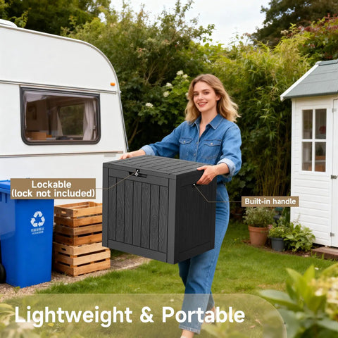 Woman holding 30 Gallon Outdoor Deck Box Lockable Waterproof Storage Container, black resin with handles, in garden setting.