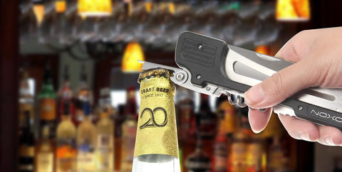 Using Six In One Folding Grill Utensils Set Featuring Fork Spatula Knife Tongs Bottle Opener And Corkscrew For Fourteen Inch Portable BBQ to open a bottle