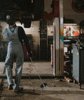 Mechanic using Telescoping Magnetic Sweeper Set With 35 Lb Magnet 3.5 Lb Magnetic Pick Up Tool in a garage