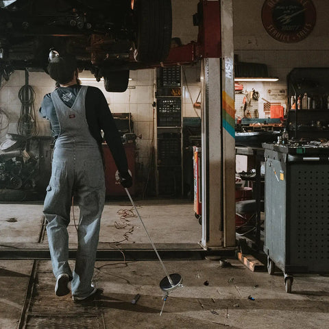 Mechanic using Telescoping Magnetic Sweeper Set With 35 Lb Magnet 3.5 Lb Magnetic Pick Up Tool in a garage