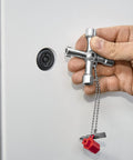 Hand using Handy Universal Control Cabinet Key for Gas, Water, and Electric Shutoff Systems with Slot 10x7 Bit near a panel lock