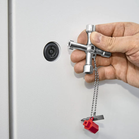 Hand using Handy Universal Control Cabinet Key for Gas, Water, and Electric Shutoff Systems with Slot 10x7 Bit near a panel lock