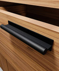 Black self adhesive edge finger pull door handle on wooden cabinet, part of a two pack, for glass, wood, metal, and plastic surfaces.