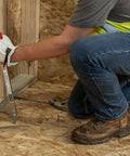 Person using Little PeeVee Sill Plate Tool for construction walls, 18 inch length steel puller, ergonomic grip, nailing aid for precision.