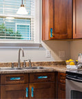 Kitchen view with Four Pack Aqua Aquamarine Blue Water Cabinet Handles Three And Three Quarters Inch Hole Centers Black Drawer Pulls installed.