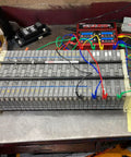 Automotive diagnostic wires connected to a car battery pack for testing and troubleshooting purposes