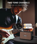 Guitarist playing with Portable 5W Mini Guitar Amplifier With Dual Speakers, Rechargeable Bluetooth Practice Amp on table.
