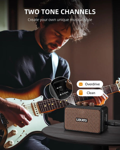 Guitarist playing with Portable 5W Mini Guitar Amplifier With Dual Speakers, Rechargeable Bluetooth Practice Amp on table.