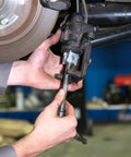 Mechanic using Rear Disc Brake Piston Tool And Caliper Compression Tool For Easy Brake Pad Change And Caliper Service With Three Eighths Inch Drive And Pro Grade Forged Steel Build For Most Cars And Light Trucks on a vehicle