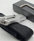 Rugged folding knife with belt clip for camping and outdoor gear, aluminum alloy T6063 handle, folded and placed on black case