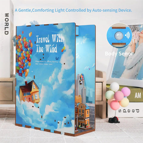 DIY Book Nook Kit For Adults With 3D Wooden Puzzle Bookend And Shelf Insert, Totally Cozy Library Decor For Shelves, Miniature House Kit With Body Motion Sensor LED Light, Travel With The Wind Edition shown with colorful sky and balloons.