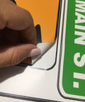 Close-up of hand peeling Road Sign Wall Decals For Kids Room Street Sign Decor Stickers Do Not Enter Stop Sign One Way Traffic Light Yield