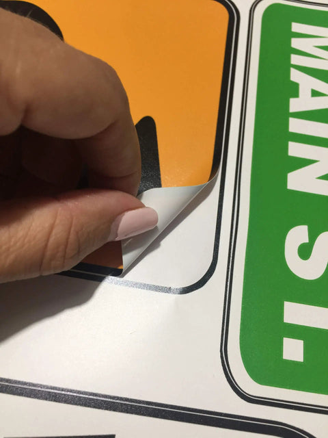Close-up of hand peeling Road Sign Wall Decals For Kids Room Street Sign Decor Stickers Do Not Enter Stop Sign One Way Traffic Light Yield