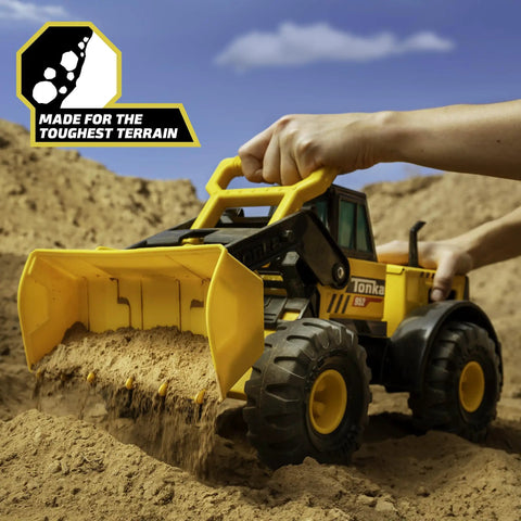 Child playing with Steel Front Loader Toy Truck for Kids Ages 3 and up, built tough with a steel frame, scooping sand outdoors.