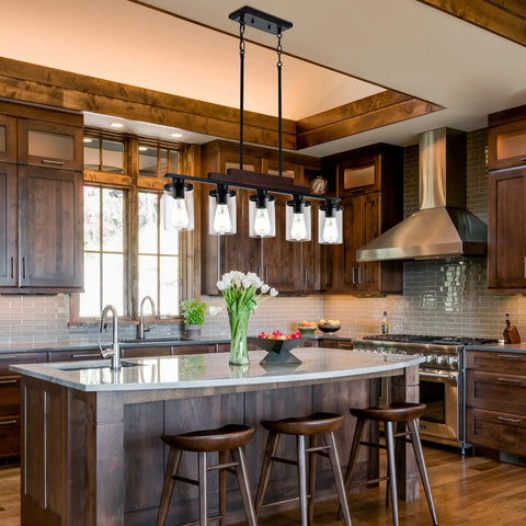 Five Light Farmhouse Dining Room Chandelier Over Table In Matte Black With Rustic Wood Accents And Clear Glass Shades in kitchen