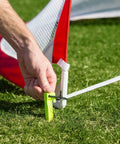 Portable Pop Up Soccer Goals For Backyard Set Of Two 4 Foot Nets being staked into the ground for stability