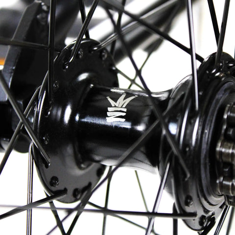 Close-up of BMX freestyle bike with durable steel frame in white, available in 16, 18, 20, 26, and 29 inch sizes, black hub detail