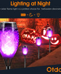Purple Flame Solar Christmas Lights Outdoor 12 Pack With Dancing Torch Effect illuminating pathway with purple glow
