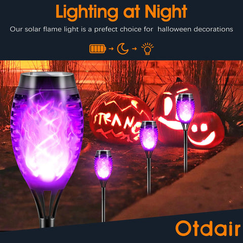 Purple Flame Solar Christmas Lights Outdoor 12 Pack With Dancing Torch Effect illuminating pathway with purple glow
