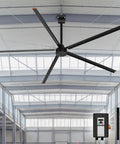 Badass 144 Inch HVLS Industrial Ceiling Fan For Warehouses And Gyms in a spacious building with remote control.