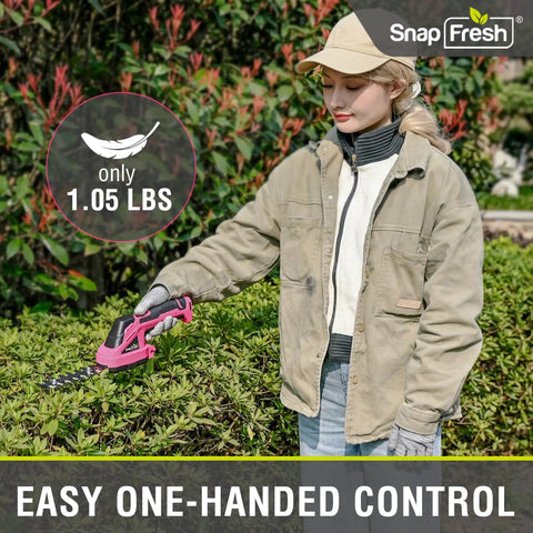 Slick Cordless Hedge Trimmer And Grass Shears 2 In 1 Lightweight Electric Bush Tool With Rechargeable Battery And Type C Charging Cable For Easy Peasy Trimming No Sweat Garden Cleanup Kit Pink held by user using one hand in a garden.