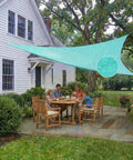 Family dining outdoors under Custom Size Triangle Shade Sail 14' X 18' X 22.8' 220 GSM Heavy Duty Sun Shade With PU Coating Waterproof