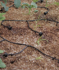 Solar Powered Automatic Drip Irrigation System With 50 Drippers And 155 Feet Of Tubing installed in a garden bed