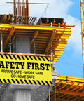 Safety First Banner Sign 2x4 Feet Polyester Fabric With Metal Grommets hanging on construction site for safety reminders.
