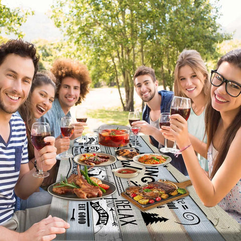 Group enjoying BBQ at picnic table covered with Outdoor 3 Piece Picnic Table Cover Set With Bench Covers For 6ft Tables Waterproof