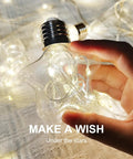 Hand holding star-shaped LED light from Star Curtain Lights With Wishing Ball LED Fairy String Lights USB Powered Remote Control 8 Modes Warm White Cozy Vibe Ambient Lighting For Backdrops Bedroom Parties Weddings Christmas Decor.