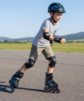 Child skating outdoors wearing Adjustable Kids Inline Skates With Four Size Settings And Bright Light Up Wheels For Boys And Girls