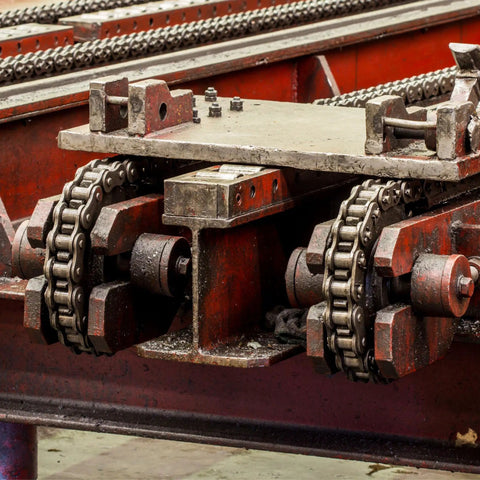 Top Shelf 3/8 Pitch 35 Chain Idler Sprocket With Single Bearing For ISO 06C Roller Chains mounted on machinery with drive chains.