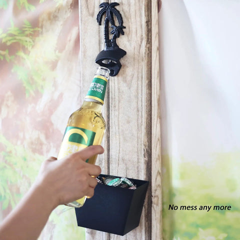Heavy Duty Black Palm Tree Wall Mounted Beer Bottle Opener With Rugged Cap Catcher Bucket in use, capturing bottle caps.