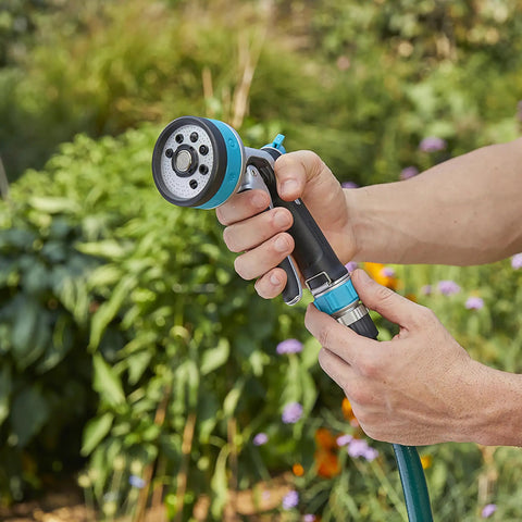 Heavy Duty Front Control Garden Hose Nozzle With 8 Preset Spray Patterns, Ergonomic Non Slip Handle, used in a garden setting