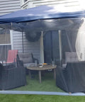 Gazebo with see-through garden netting covering outdoor furniture for insect protection, highlighting UV resistant mesh.