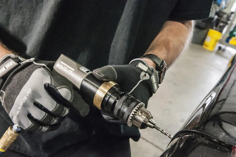 Worker using Three Eighths Inch Pneumatic Reversible Drill With Variable Speed Up To 2000 RPM on metal surface.