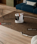 Portable Upholstery And Carpet Cleaner With 15KPa Suction And 500W Motor in living room on rug showing power cord and hose