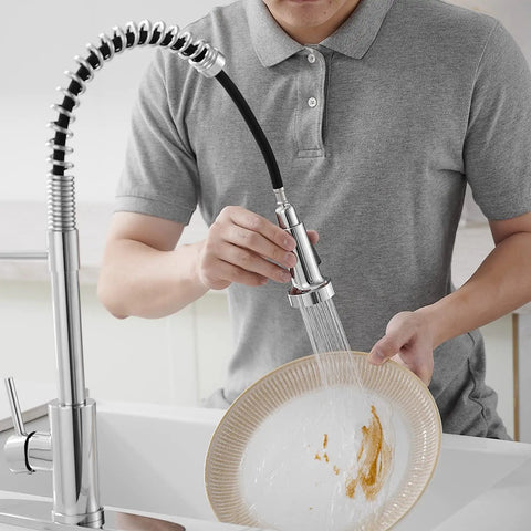 Person using Chrome Kitchen Faucet With Pull Out Sprayer, Commercial Spring Design, High Arc Spout, 360 Degree Swivel on dish