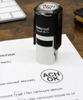 Custom Round Self Inking Stamp With Sleek Pocket Design For Fast Inspections Or Approvals Boasting Smooth Action And Hella Easy Up To Three Line Customizing In Fifteen Bold Ink Shades For Office Crews Wanting A Solid Go To Hand Stamping Tool on a printed application form.