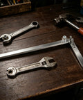 Penitue Manual Wire Bending Tool For Desktop, ferroalloy steel tool with wrenches on a wooden workbench.