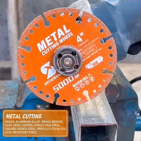 Front view of an orange 4-inch diamond metal cutting wheel with 7/8-inch arbor mounted on a grinder.